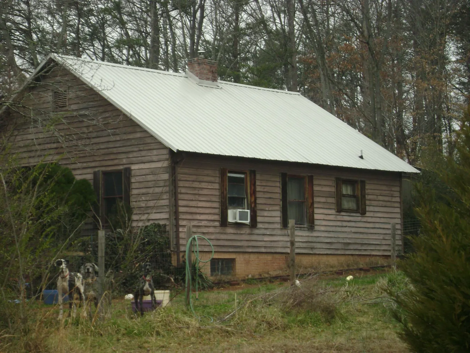 White metal roof on an old wood sided farmhouse, from a Asphalt Shingle Roof Repair job in North Olmsted